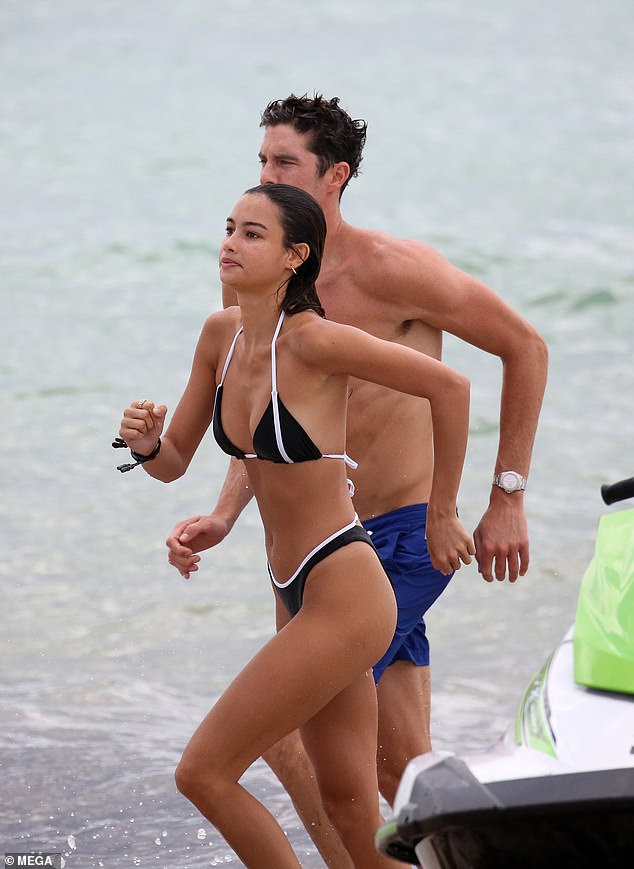 Making a splash: The happy couple ran down the shoreline