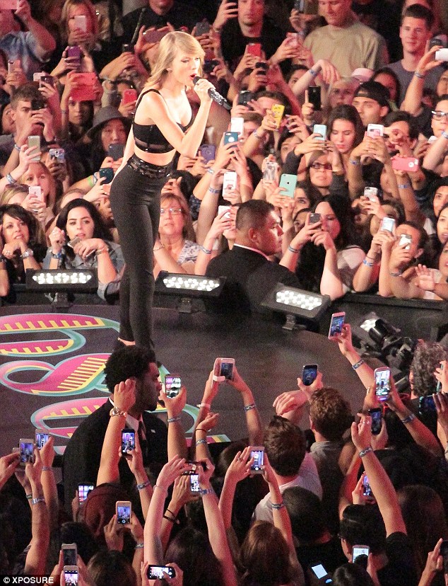 Say cheese: The camera phones are out in full force as Taylor performs another track 