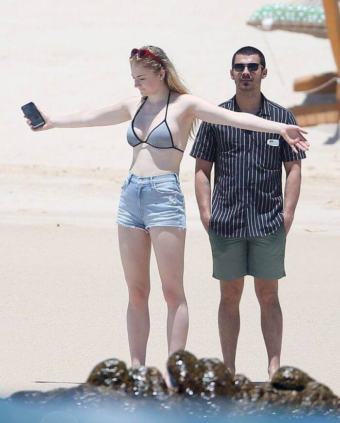 hollywood sophie turner in bikini bra on beach wearing bikini bra with denim shorts