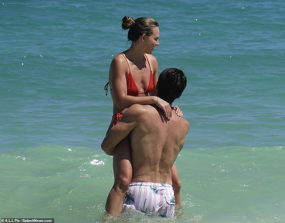 Bachelorette vet Hannah Brown models a red bikini with fiancé Adam Woolard  in Mexico... after revealing proposal led to panic attack