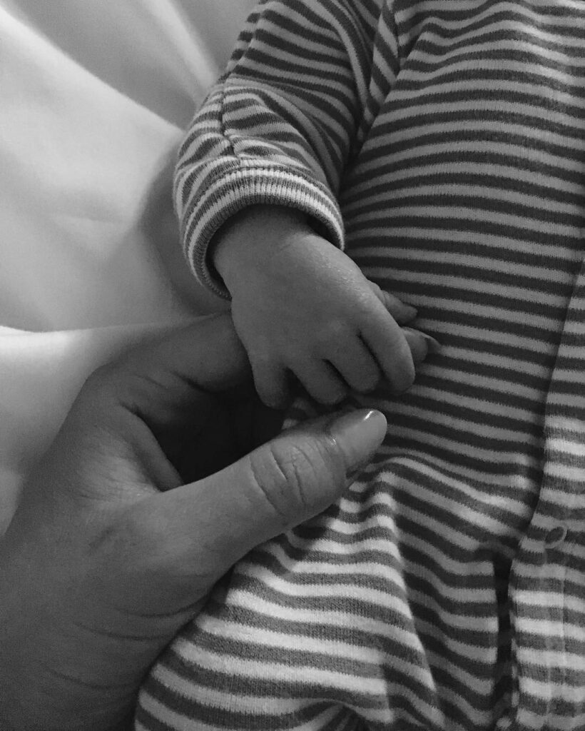 Rosie Huntington-Whiteley holds her baby's hand.