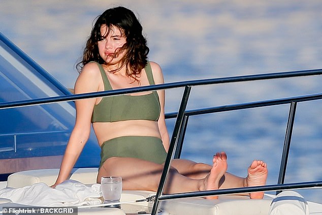 Simply stunning: Selena sported an olive green bikini featuring a sport top and high-waisted bottoms