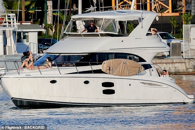 Making a splash: She certainly seemed to be in good spirits as she laid out next to a gal pal while tanning on board of the extravagant watercraft