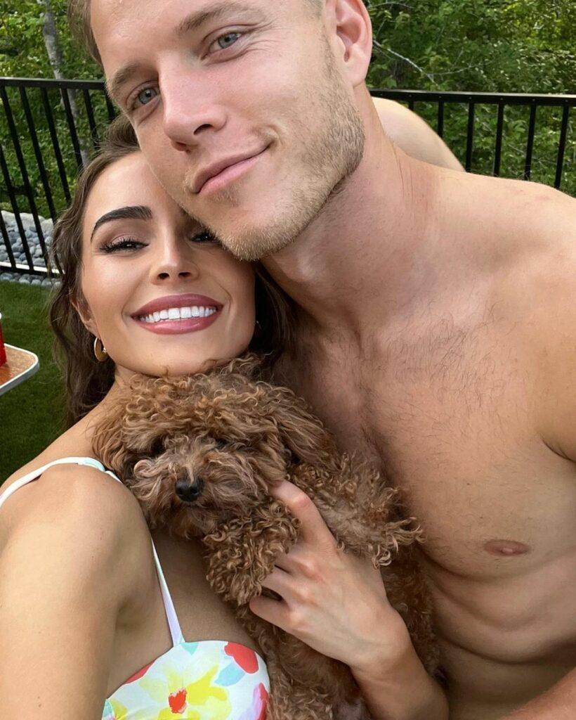 Olivia Culpo and Christian McCaffrey smiling.