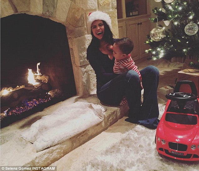 Bonding time: Last week, the 23-year-old spent time with her godson, Aiden, over her Christmas break