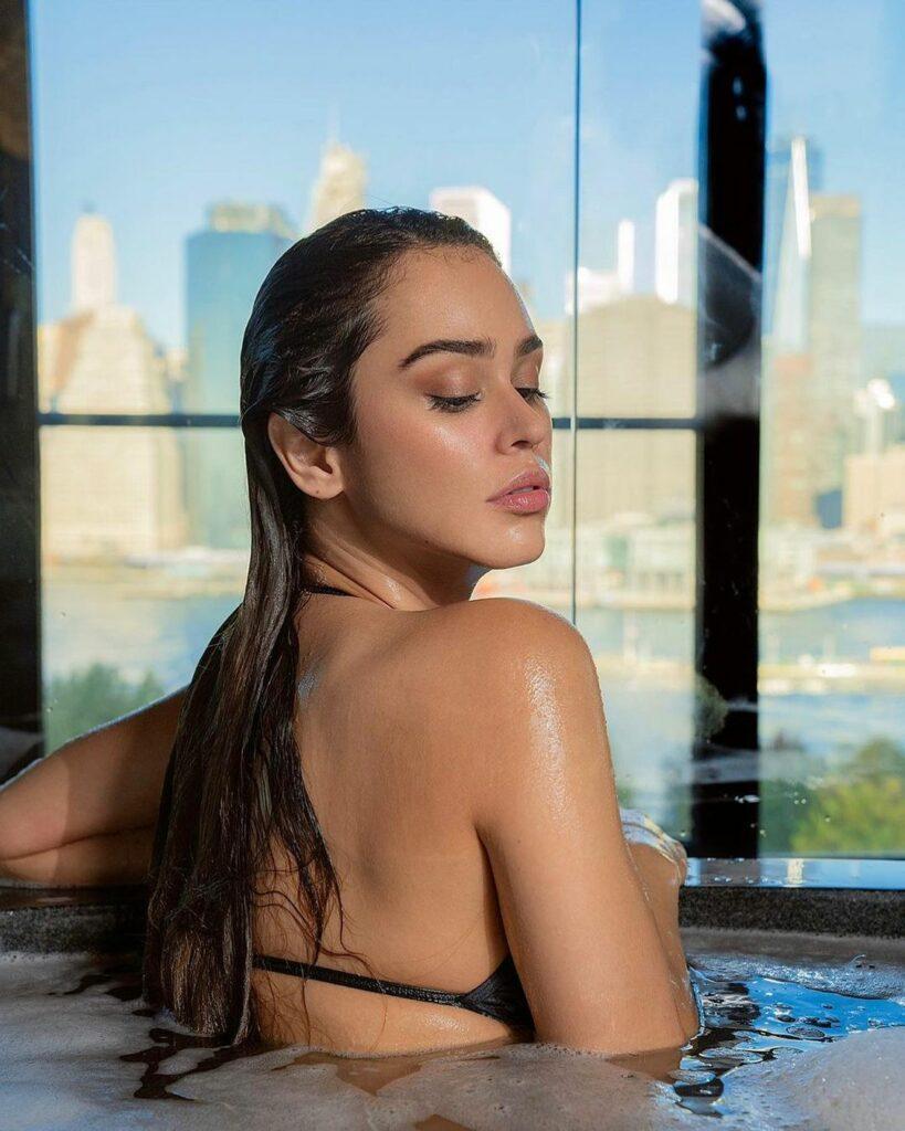 Yanet Garcia posing in the hot tub.