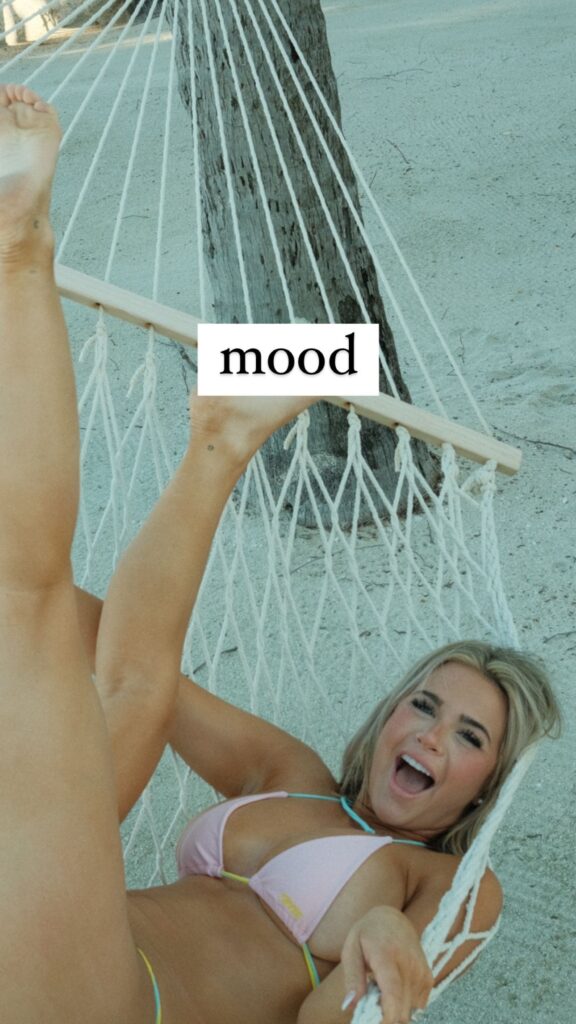 Emily Elizabeth lounges on a hammock while wearing a bikini.