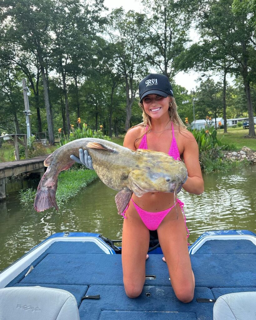 Brylie St. Clair shows off her big fish while wearing a pink bikini.