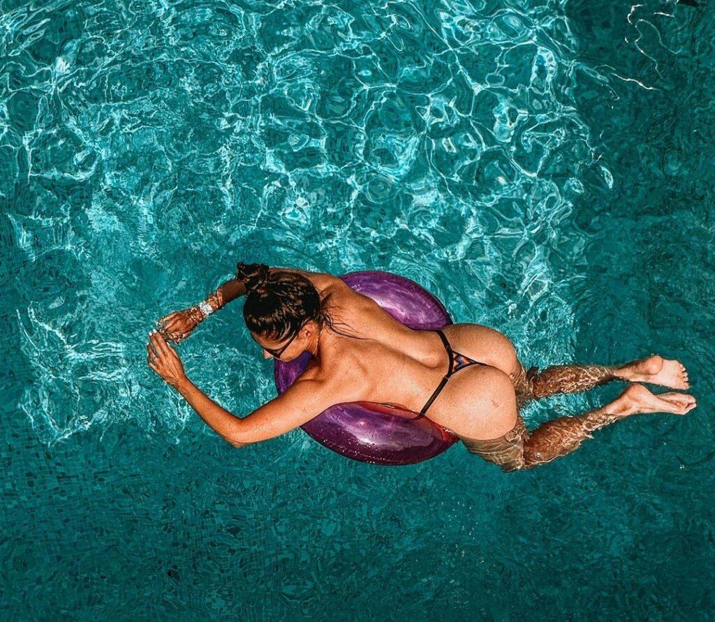 Alexandra Ianculescu hangs on a pool floatie.