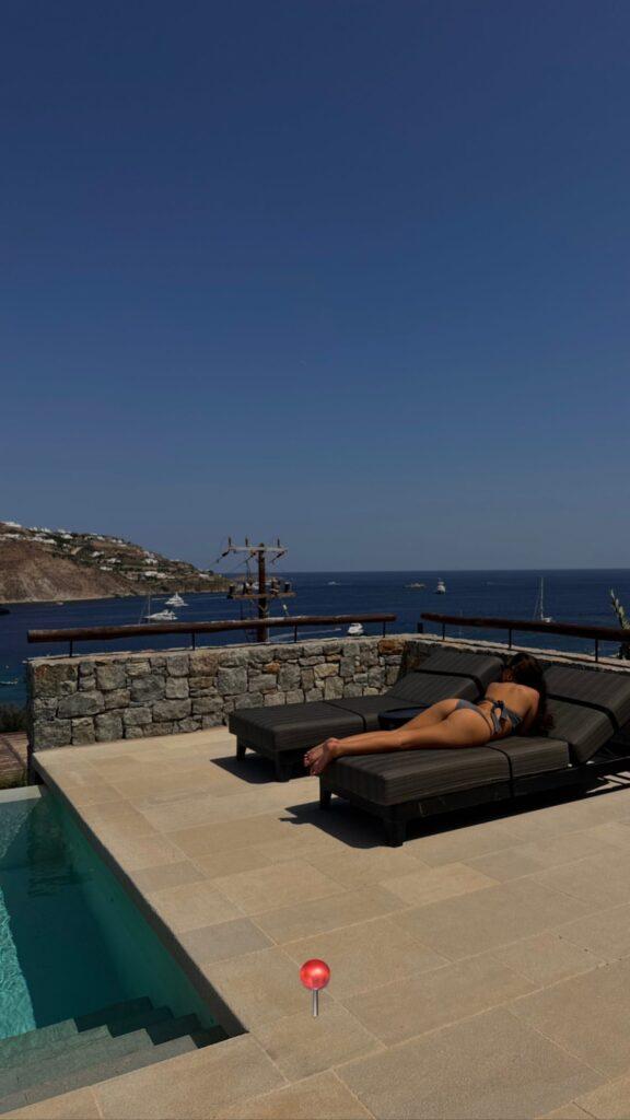 Madison Pettis suns her buns in Mykonos, Greece.