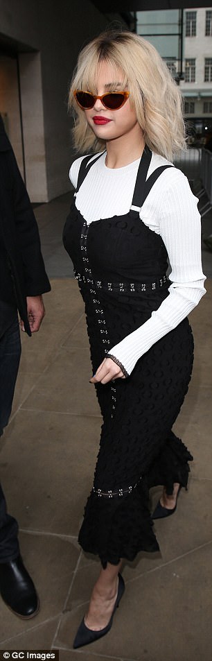 Chic: Leaving BBC Radio 1, she opted for a monochromatic black dress which was layered above a white woolly jumper