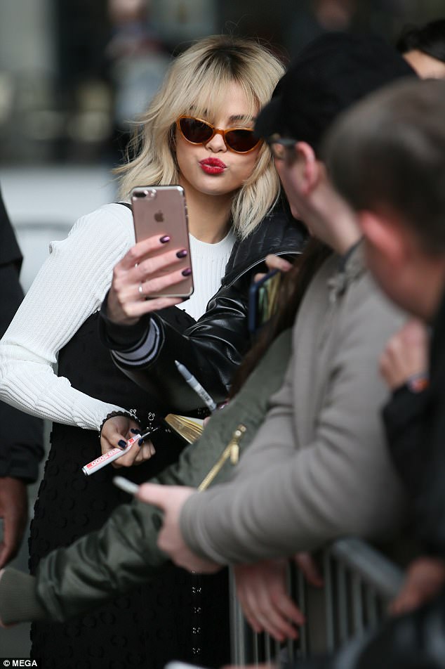 Dedicated: The singer proved she's devoted to her fans as she braved the cold to sign autographs and pose for photos