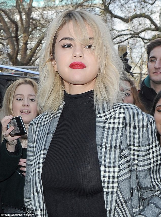 Peek-a-boob! While her fourth look, a knitted black dress paired with a tailored checked jacket, appeared to be the most demure of the day, it was a different story upon closer inspection