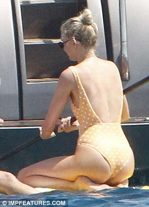 Shore thing: Her swimsuit also featured a low-cut back