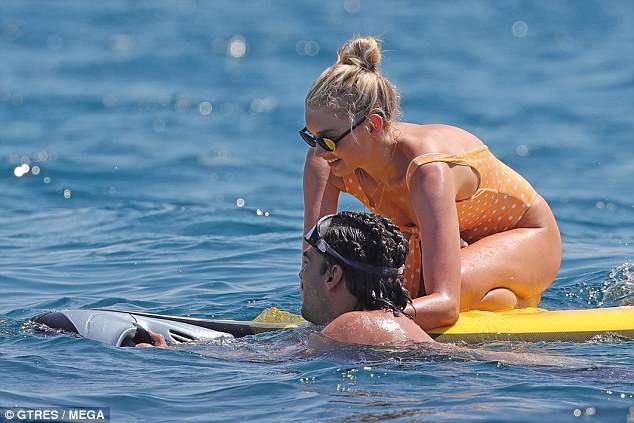 Water about that: She paddled out on a surf board during her afternoon