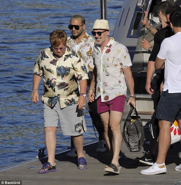 Gucci gang: Elton was kitted out head-to-toe in Gucci, donning £670 cotton shorts and £270 purple-tinted sunglasses. His husband David also blew the bank with a ,675.00 bag