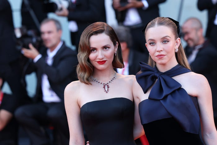 Maude Apatow and Sydney Sweeney in black gowns standing next to each other