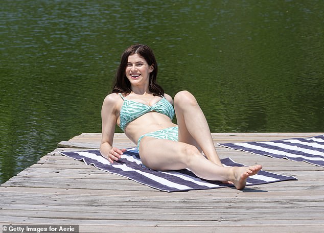 Beaming: The star beamed as she relaxed on the dockside on a comfy striped towel