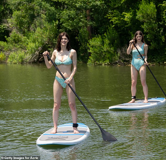 Great fun: The pair paddled along the ride on their individual boards, first on their knees before later climbing to their feet