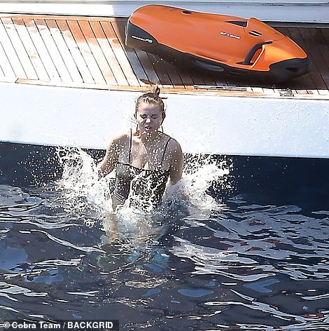 Splashing around: Selena was seen jumping into the sea