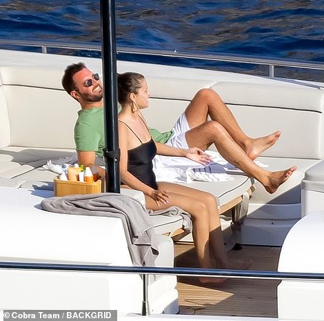 The best day: Andrea was seen sunbathing and chatting away to Selena during the trip