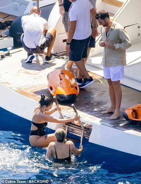 Boat trip: Selena climbed out of the sea after her swim with a friend