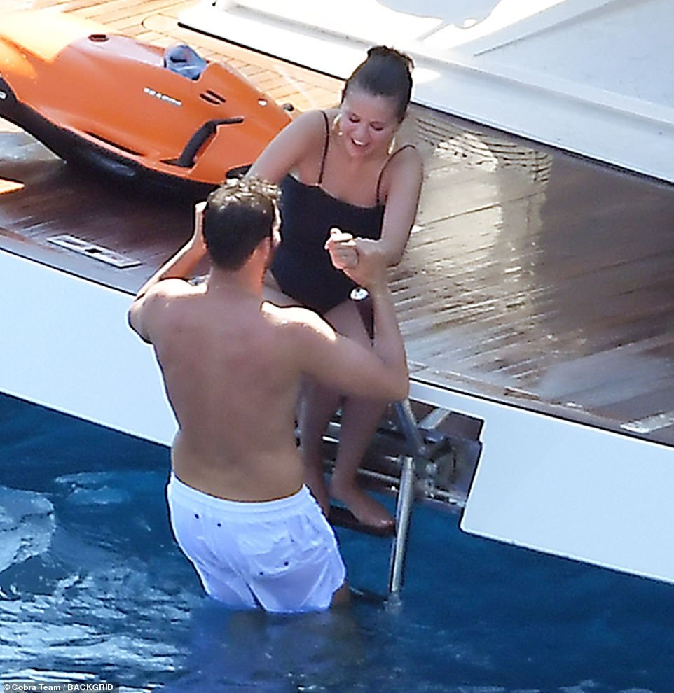 Cosy: The actress, 30, was seen chatting and larking around with Italian producer Andrea as he held her hands and helped her into the ocean for a swim as she sat on the side of the boat