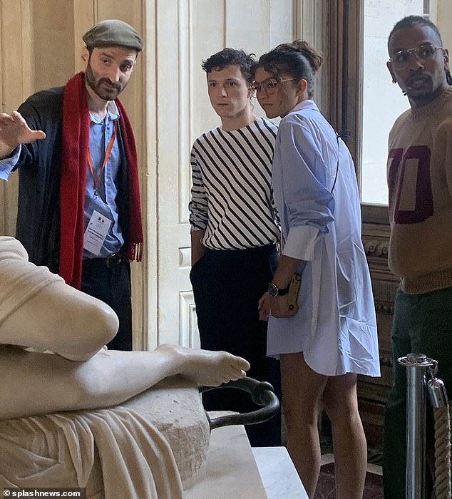 Taking a tour: The two talented stars were pictured listening to their tour guide as they were shown around the museum on Friday