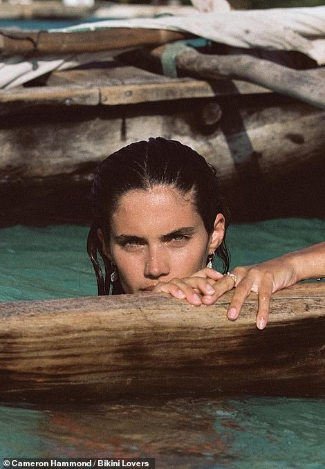 A long look: The brunette stayed comfortably in the water as the photographer got multiple different angles that showed off her figure