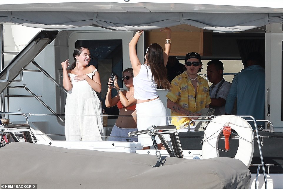 Having a blast: Nicola wore a white knee-length skirt with a white triangle bikini, adding a white T-shirt and matching headband