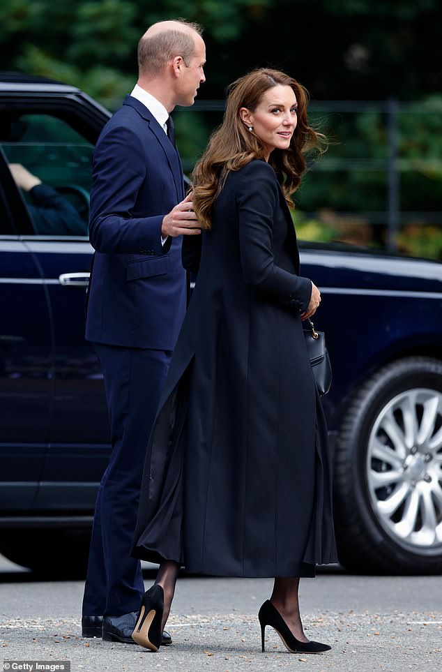 The Prince of Wales places a hand on Kate's back after greeting mourning royal fans on the Sandringham estate in September 2022