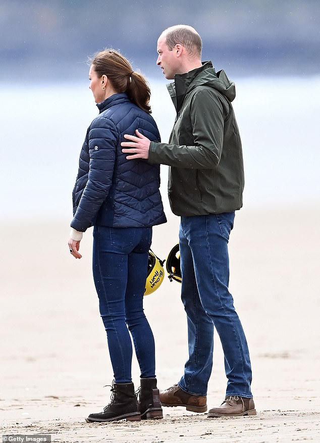 In May 2021, the couple returned to St Andrew's University for a series of royal engagements. Prince William pictured putting his hand on his wife's back