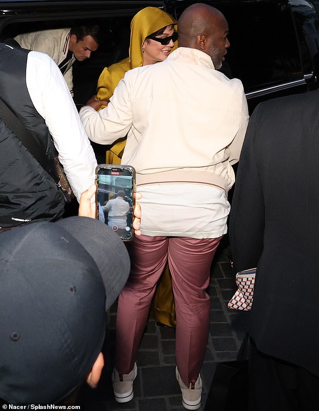 Fashionable comfort: Corey, who has been dating Kris since 2015, also dressed to impress for the dinner outing on Sunday, and donned a white shirt which was layered with a cream-colored sports jacket