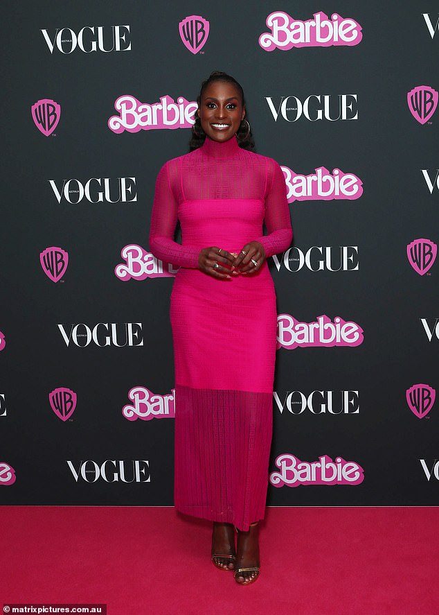 She added a smattering of rings as well as a pair of large hoop earrings while wearing her hair pulled back in a half-up bun