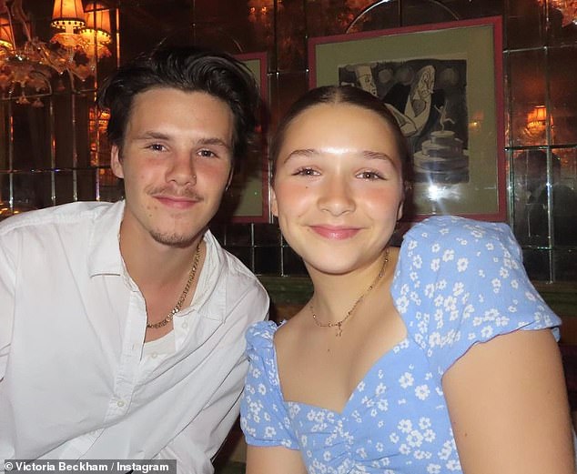 Siblings: Harper sported a blue floral dress and white trainers as she posed alongside her brother Cruz