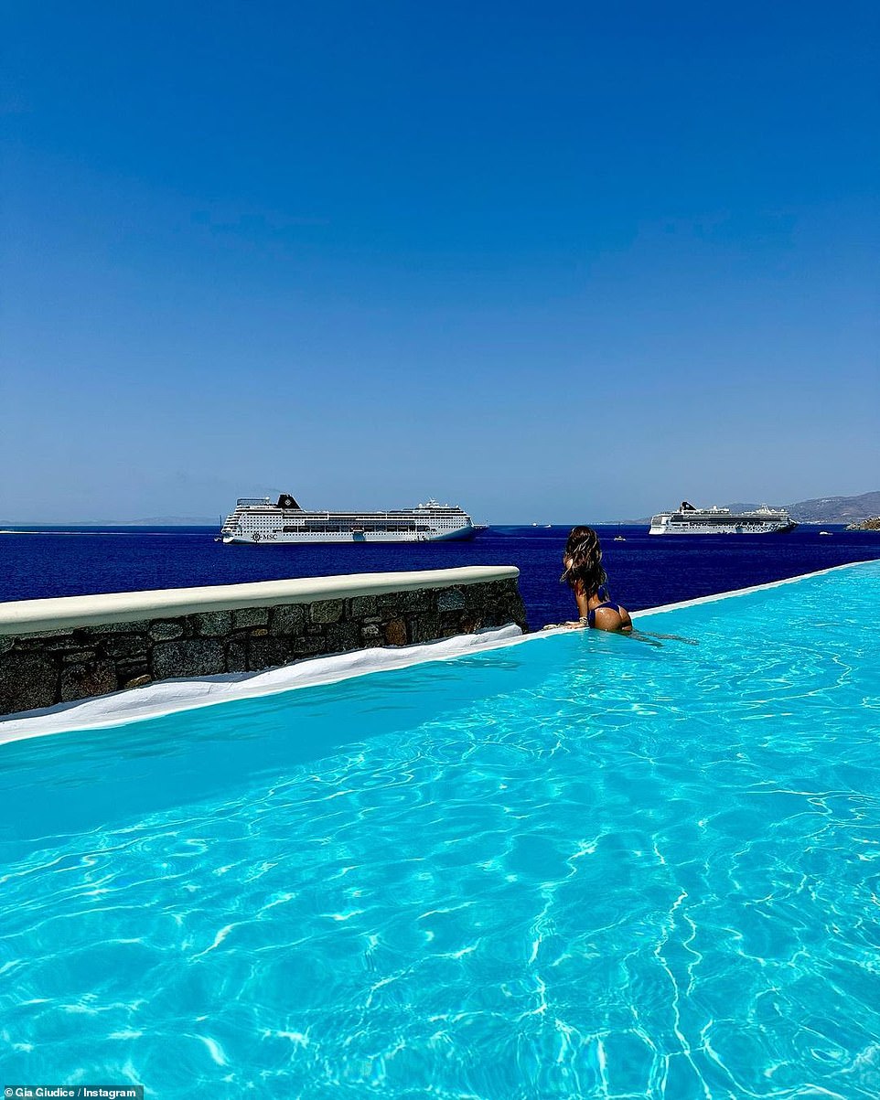 A very nice view: She showed off her thong style bottoms as she pulled herself out of the pool to look at the cruise ships