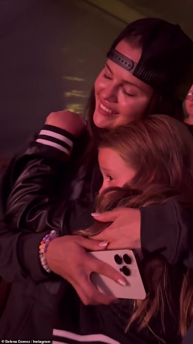 Making memories: The video began with a shot of the stage but then quickly panned over to show the actress hugging her sister, Gracie