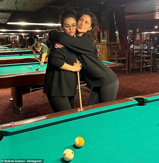 Fun times: She also included a snap of herself posing with who appeared to be close pal, Nicola Peltz, while they were playing a game of billiards