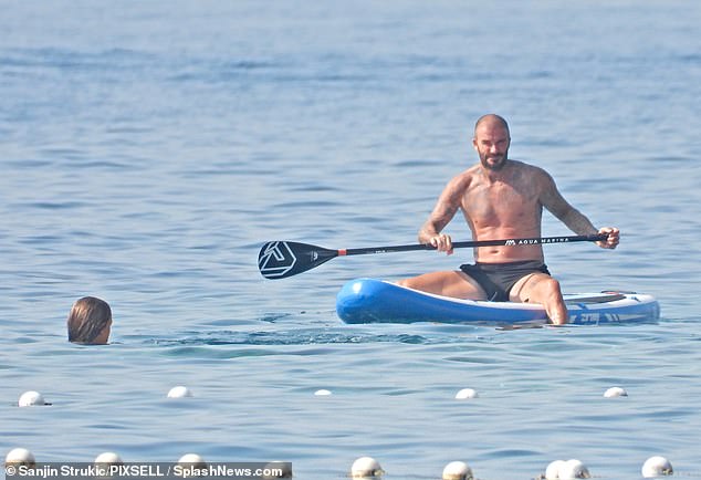 Balmy: They cooled off with a dip in the sea and enjoyed trying their hand at watersports