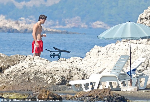 Sun-soaked: Cruz also lounged in the sun as well as jetting around in the sea