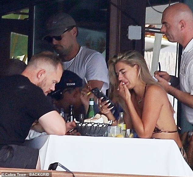 Fun in the sun: Arabella's work trip came after she spent the summer partying with Leonardo DiCaprio (centre) and his famous pals on his yacht in Ibiza