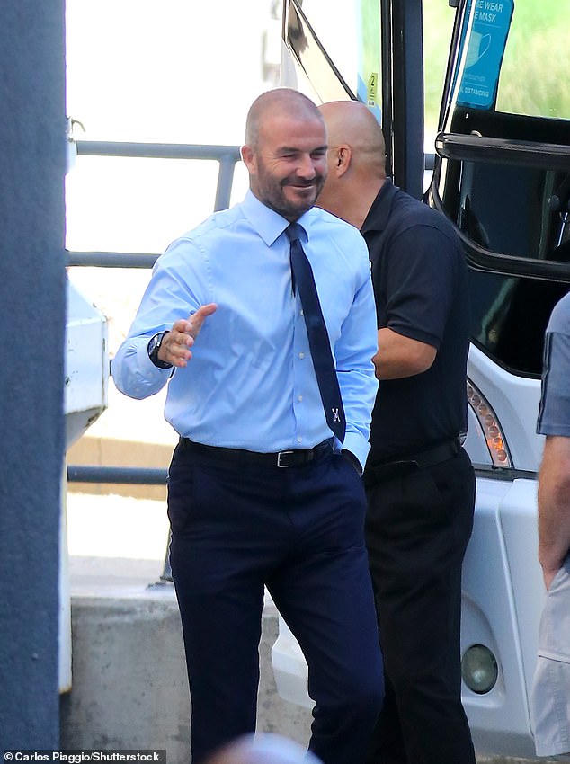 All smiles: He was shaking hands and smiling ahead of his pitchside support