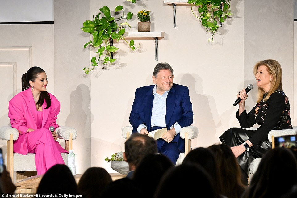 Pretty in pink! The 31-year-old 'Texican' pop star looked sophisticated wearing a Barbie-pink wool Giuseppe Di Morabito pantsuit as she joined Universal Music Group CEO Sir Lucian Grainge (M) and Thrive Global CEO Arianna Huffington (R) onstage the 1 Hotel West Hollywood