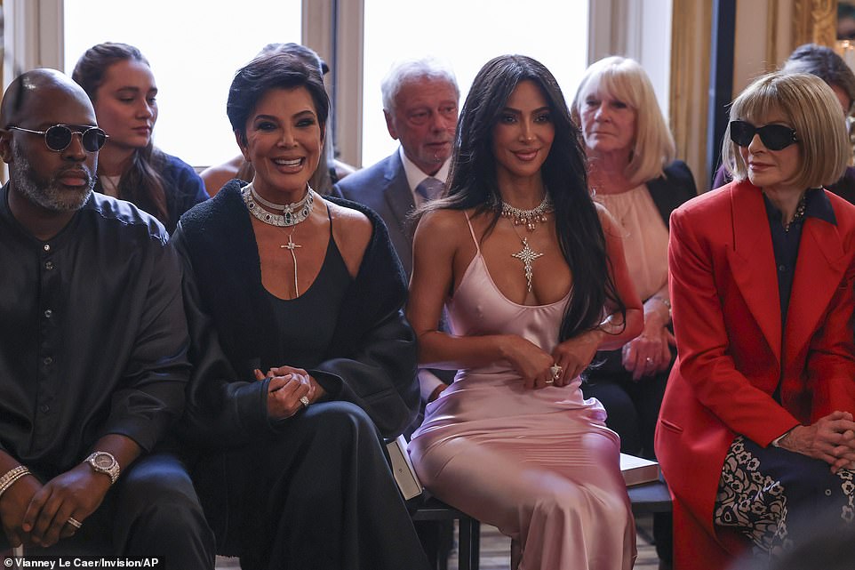 All stars: Kim was seen sitting alongside her mother Kris Jenner (second left) and Kris's partner Corey Gamble (left), while Anna (right) also sat on the front row