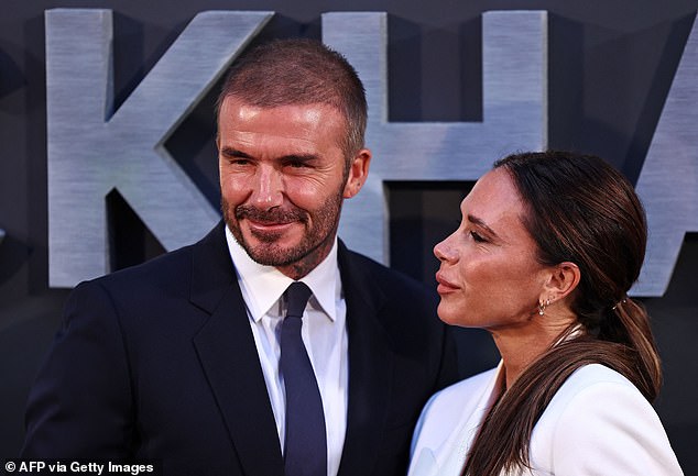 Look of love: The fashion designer toted her essentials in a small black clutch bag with a gold clasp as she smiled for snaps with her husband of 24 years