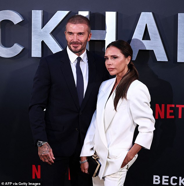 Suave: David cut a dapper figure in a navy suit and brown loafers as he continued to show off his newly shaved buzzcut at the premiere