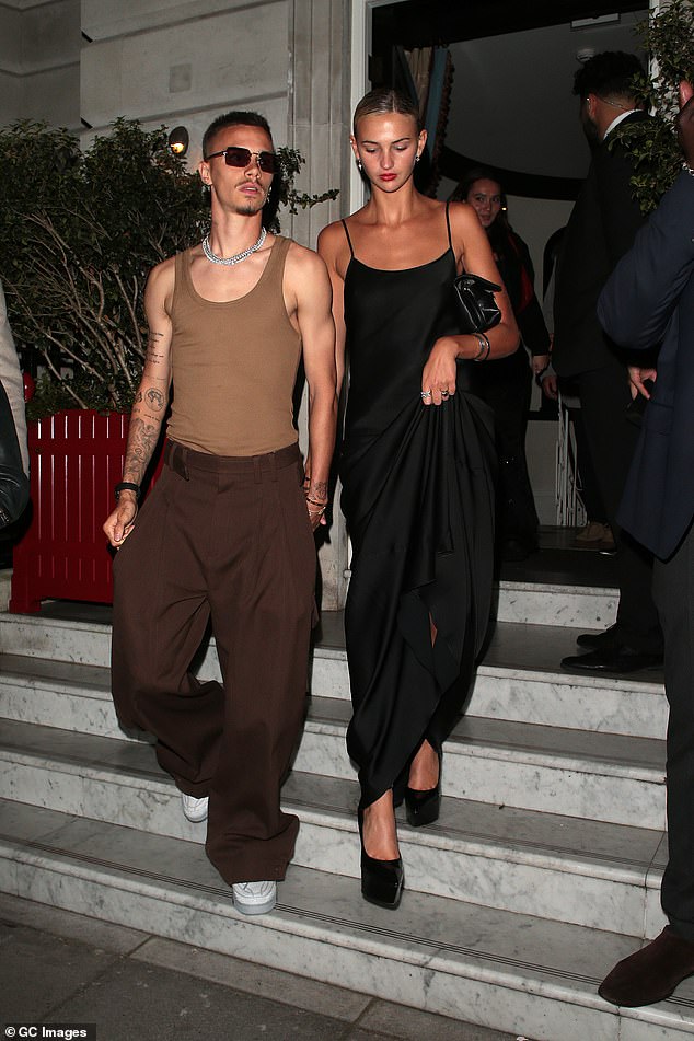 Handsome couple: Victoria and David's son Romeo and his model girlfriend Mia Regan were also present at the afterparty