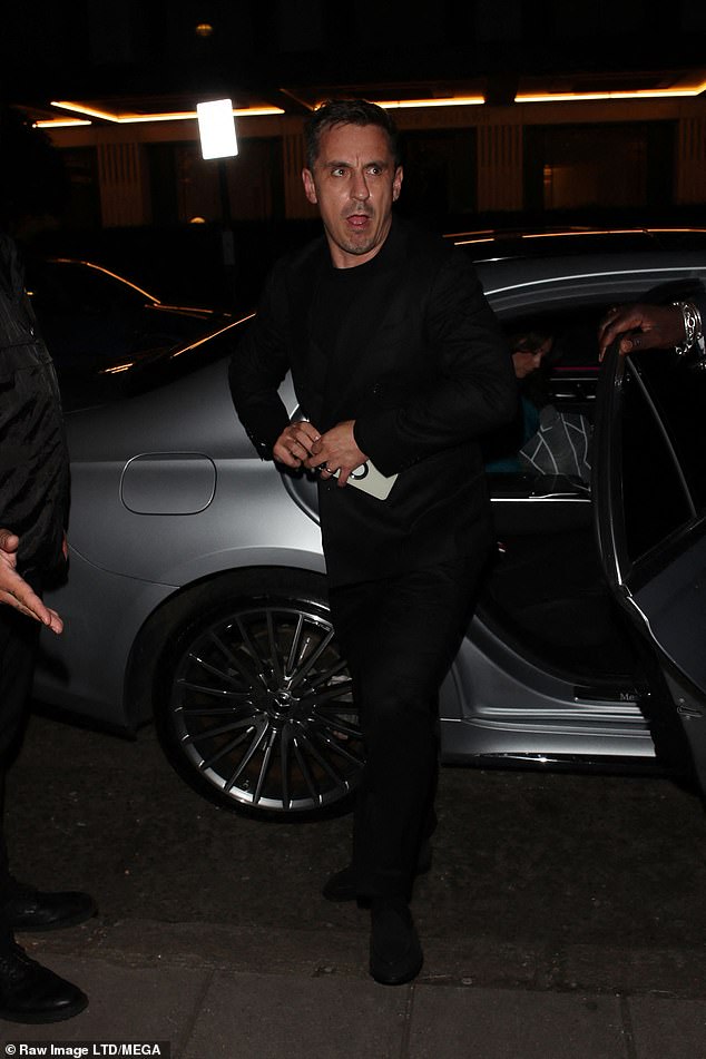 Excited: The footballer looked thrilled, dressed in a smart black double-breasted suit with a matching T-shirt and shoes