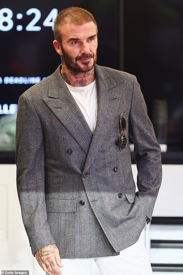 Slick: David topped off his look with a pair of smart trousers and took some circular sunglasses into his top pocket