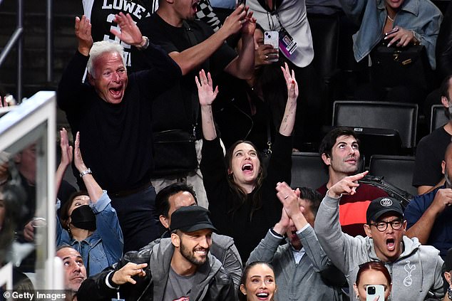 Arms up: The game got exciting for Ashley who threw her arms up in the air